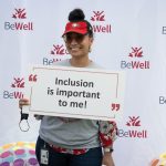 Person holding a sign about inclusion at the Cardinal Walk